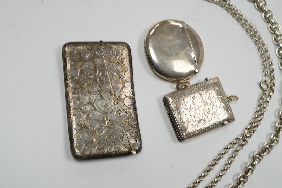 An Edwardian engraved silver sovereign case, Birmingham, 1905, on a silver chain, one other sterling chain, two silver vesta cases and a silver card case. Condition - poor to fair